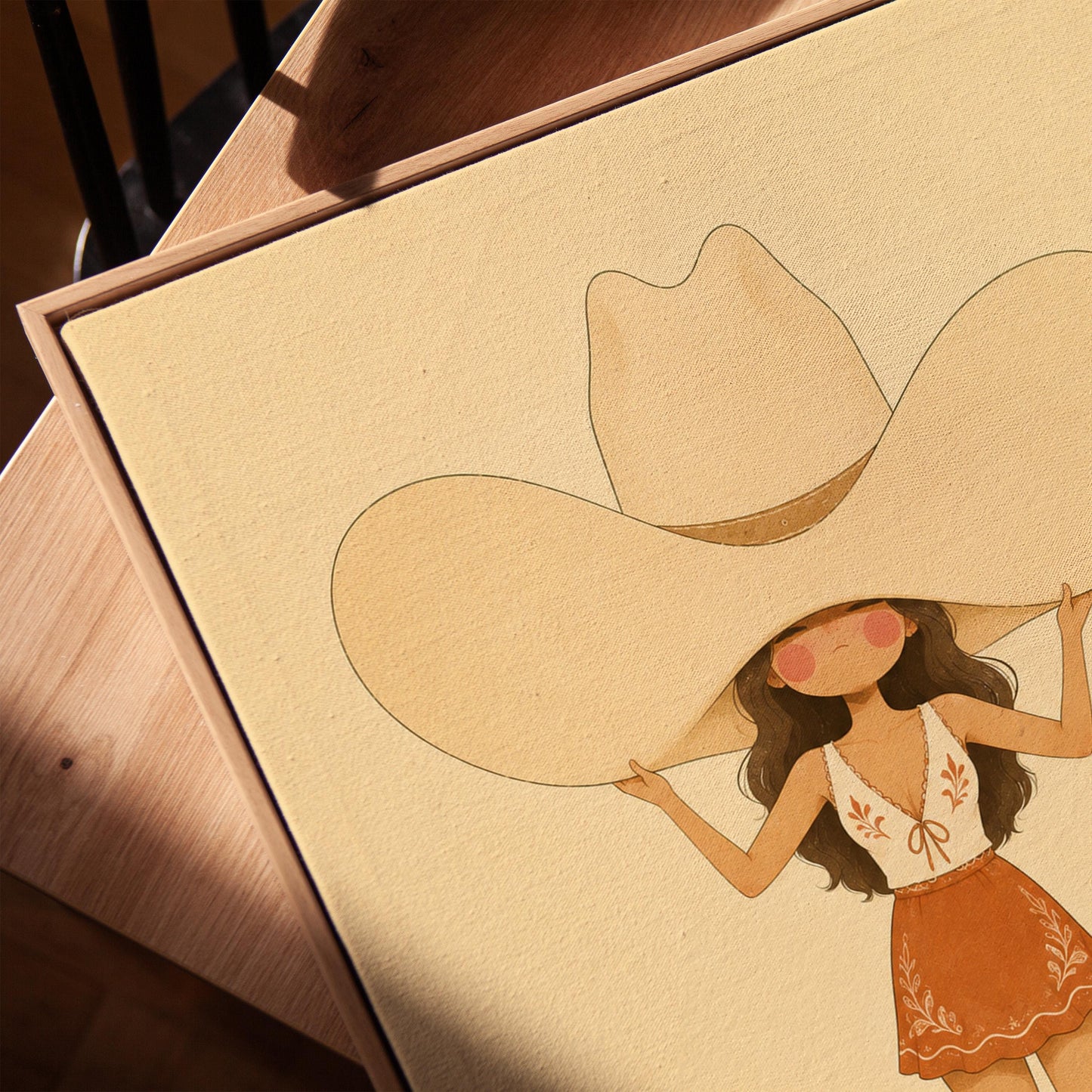 Cowgirl lifting an oversized cream cowboy hat above her head in tall boots, canvas print in a warm, minimally styled interior