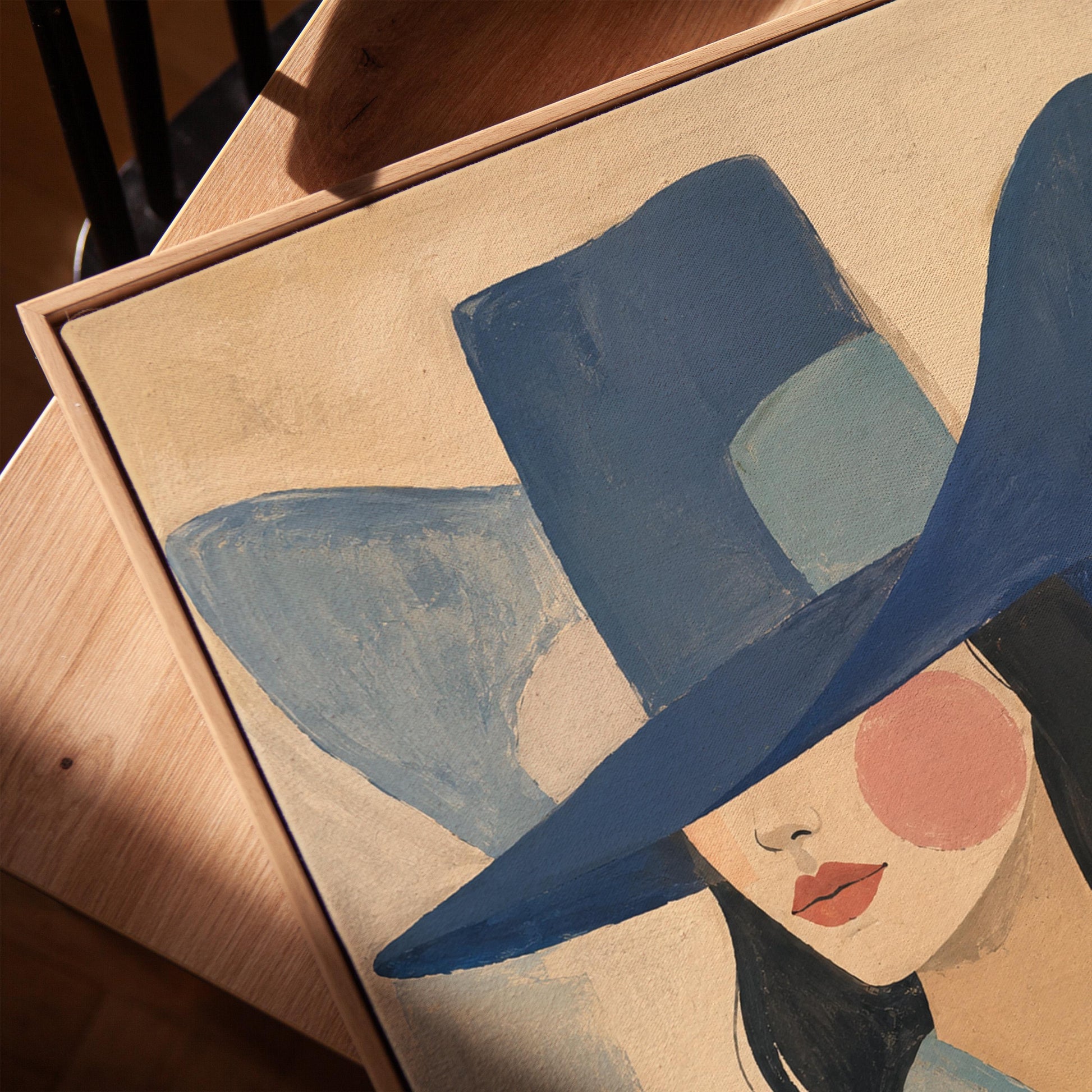 Cowgirl in a deep blue hat and pale scarf on a soft abstract ground, canvas print in a warm, minimally styled interior