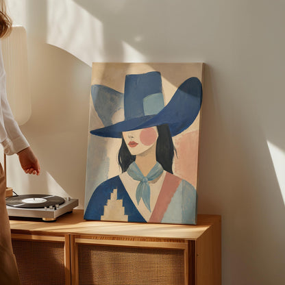 Cowgirl in a deep blue hat and pale scarf on a soft abstract ground, canvas print shown in a sunlit, contemporary room