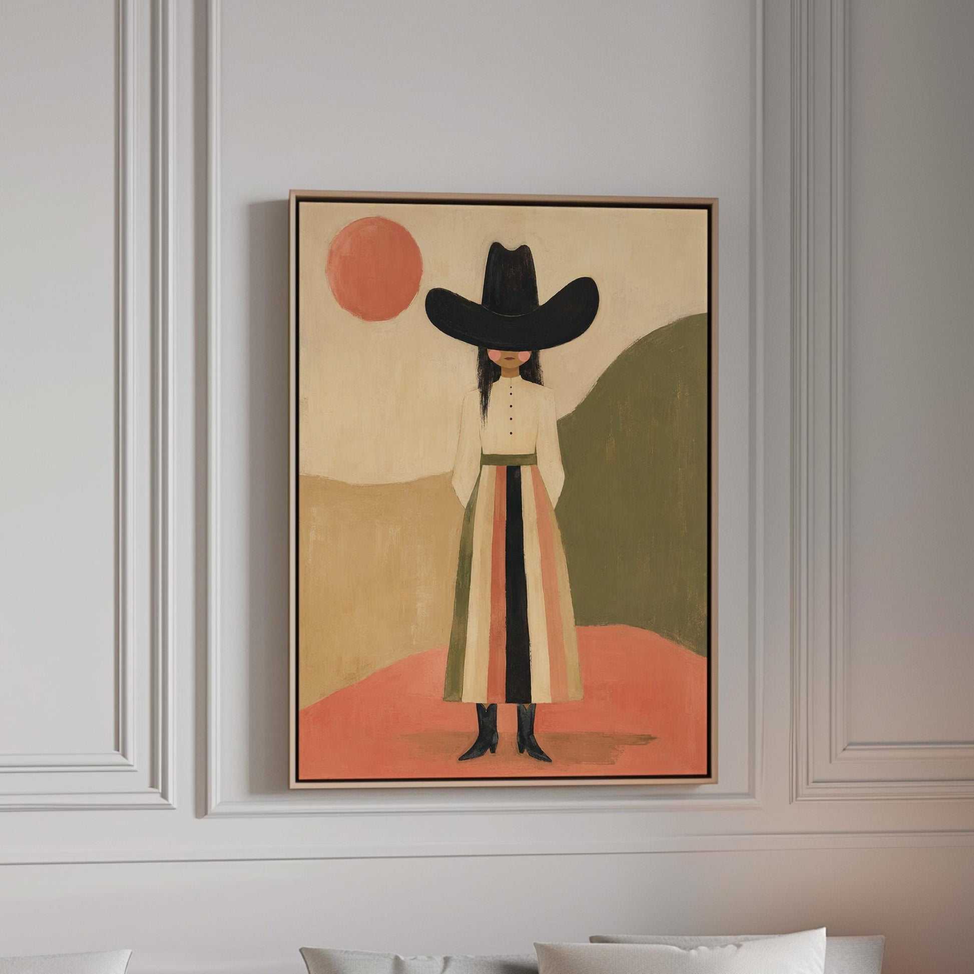 Figure in black cowboy hat standing between coral desert hills, canvas print in a bright room with natural daylight