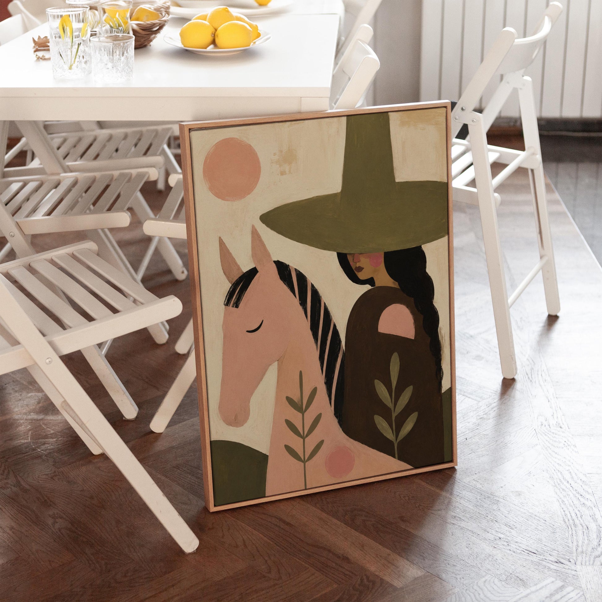 Pink horse beside a cowgirl in an olive hat with leaf motifs, canvas print on a quiet wall in a considered interior