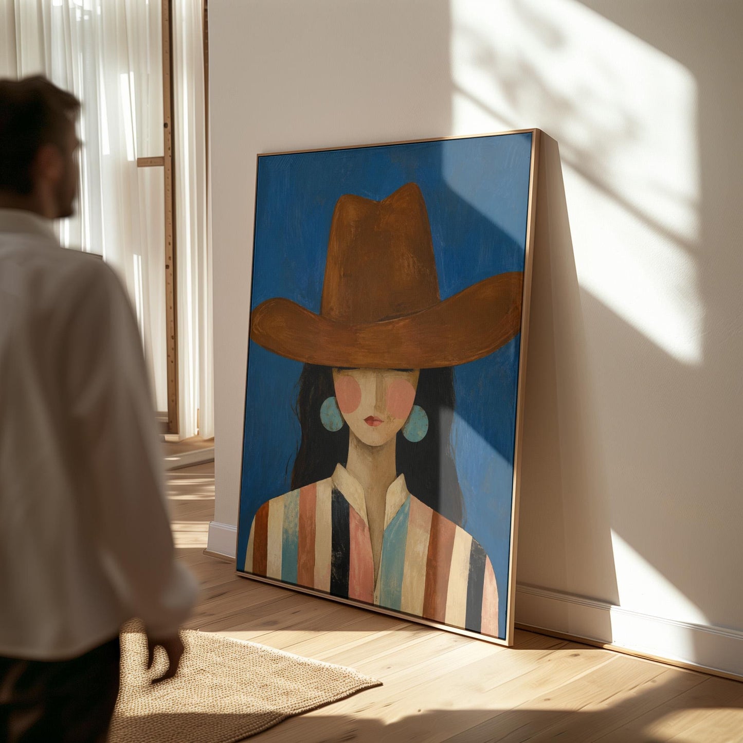 Cowgirl in a brown hat and turquoise earrings on cobalt blue, canvas print shown in a sunlit, contemporary room