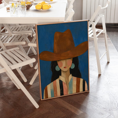 Cowgirl in a brown hat and turquoise earrings on cobalt blue, canvas wall art presented in a light, minimal room