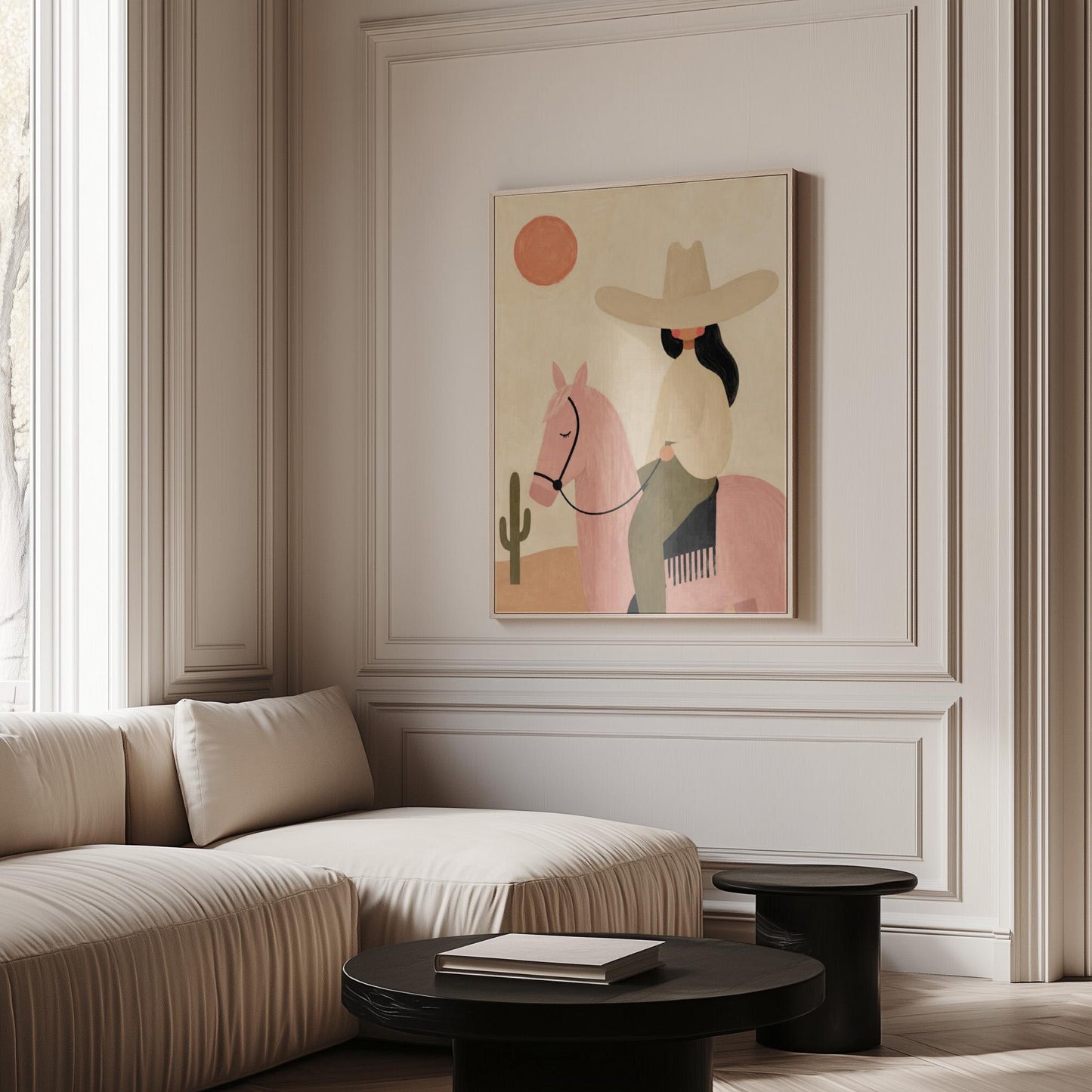 Cowgirl in a pale hat riding a soft pink horse past a desert cactus, canvas print shown in a sunlit, contemporary room