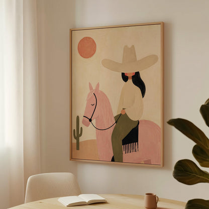 Cowgirl in a pale hat riding a soft pink horse past a desert cactus, canvas print hanging in a calm, modern living space