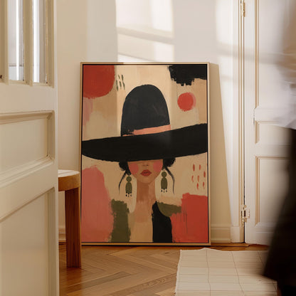 Woman in a wide black hat with olive earrings on red brushwork, canvas print shown in a sunlit, contemporary room