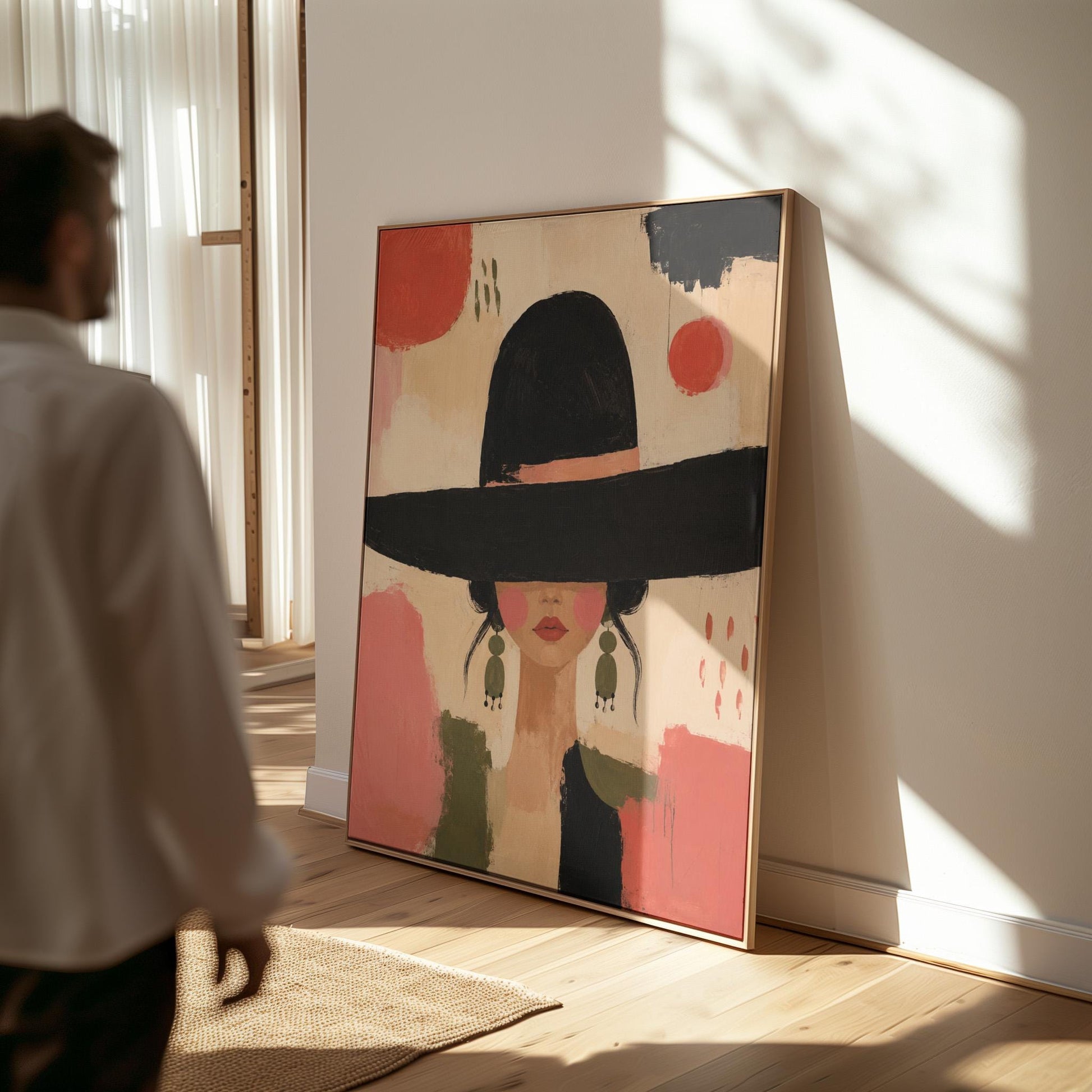 Woman in a wide black hat with olive earrings on red brushwork, canvas wall art seen in a warm interior with natural light