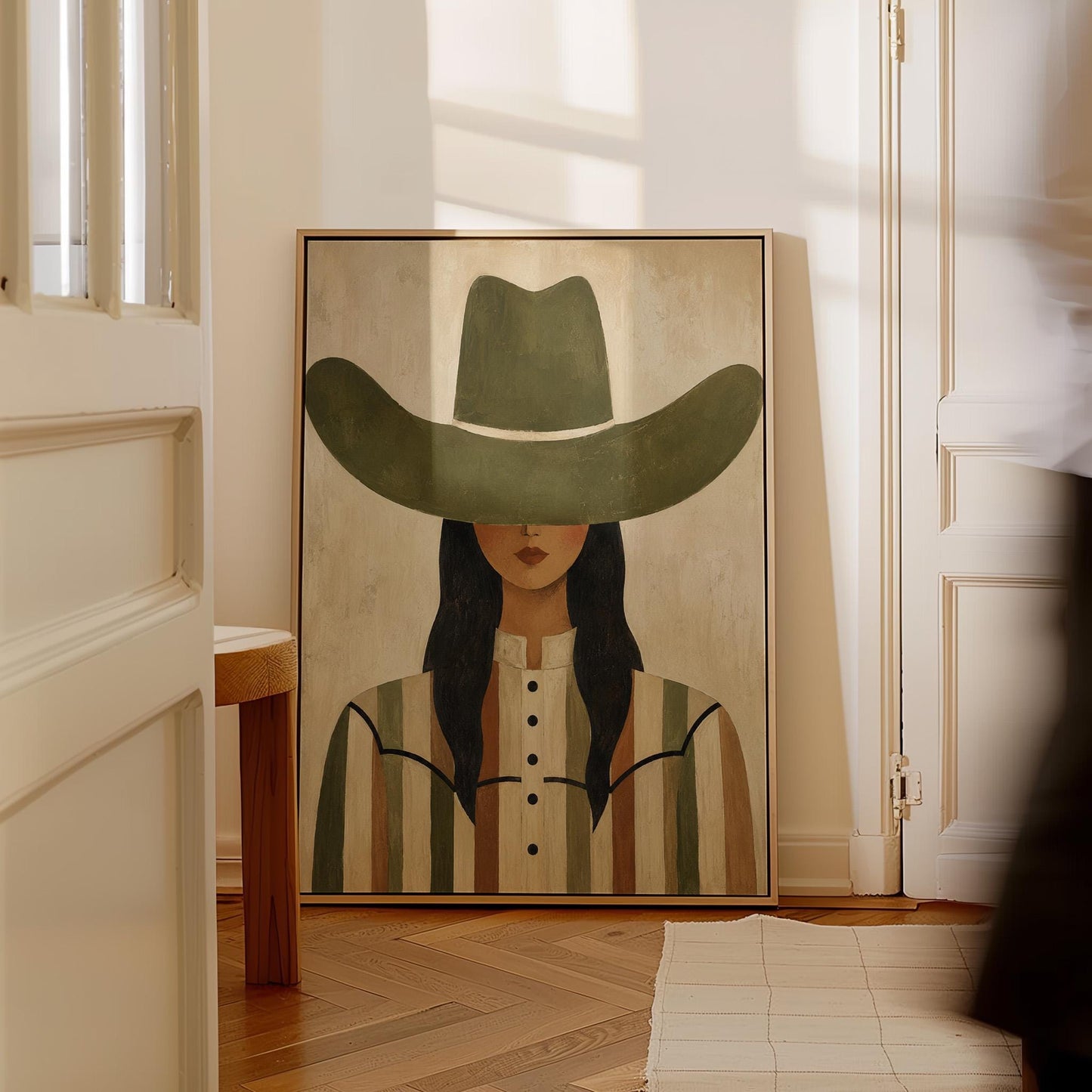 Cowgirl in olive hat and striped western shirt on sandy beige, canvas print styled against a soft white wall