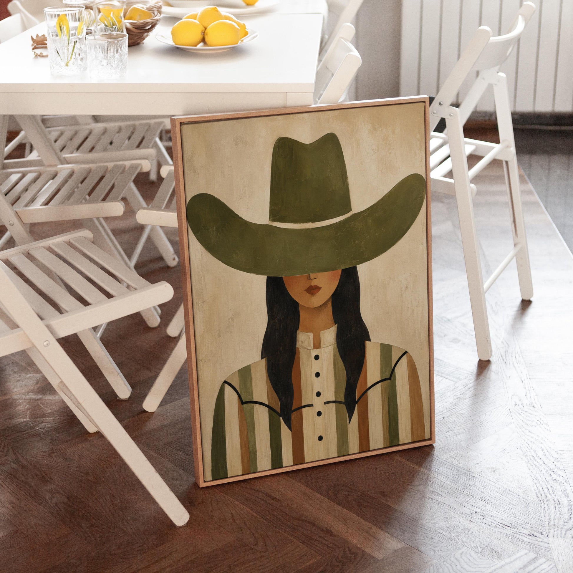 Cowgirl in olive hat and striped western shirt on sandy beige, canvas wall art styled against a soft white wall