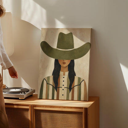 Cowgirl in olive hat and striped western shirt on sandy beige, canvas wall art on a quiet wall in a considered interior