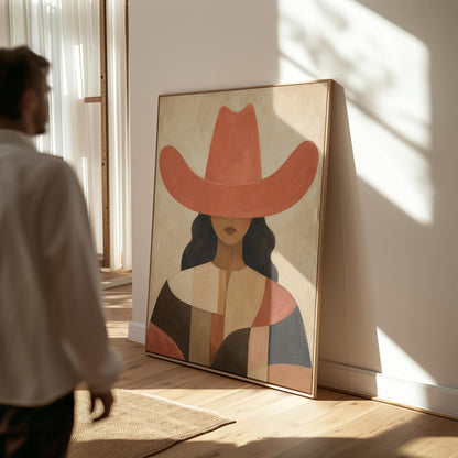 Cowgirl in a broad terracotta hat and patchwork western shirt, canvas print presented in a light, minimal room