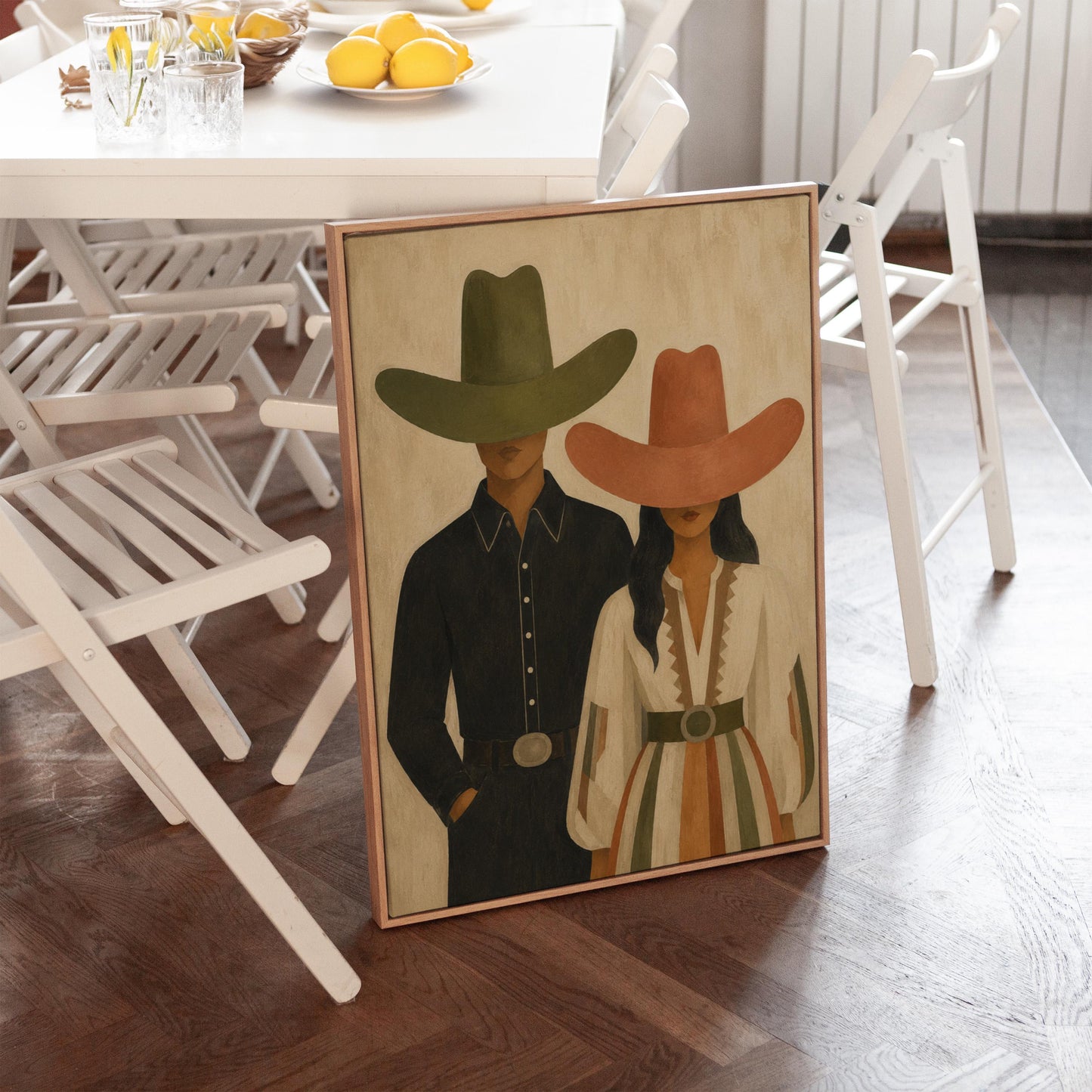 Cowboy and cowgirl standing side by side with hats tipped low, canvas print shown in a sunlit, contemporary room