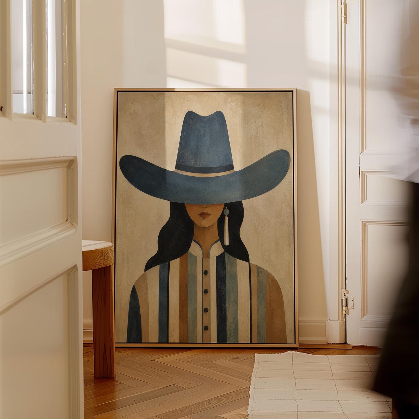 Cowgirl in a slate blue hat and striped shirt on warm sand, canvas print seen in a warm interior with natural light