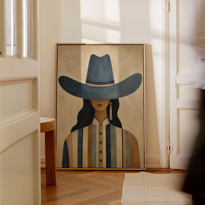 Cowgirl in a slate blue hat and striped shirt on warm sand, canvas print seen in a warm interior with natural light