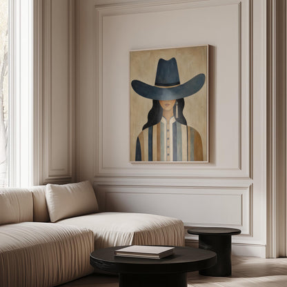 Cowgirl in a slate blue hat and striped shirt on warm sand, canvas wall art styled against a soft white wall