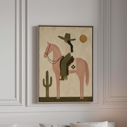 Cowgirl on a dusty pink horse beside a tall saguaro cactus, canvas print in a bright room with natural daylight
