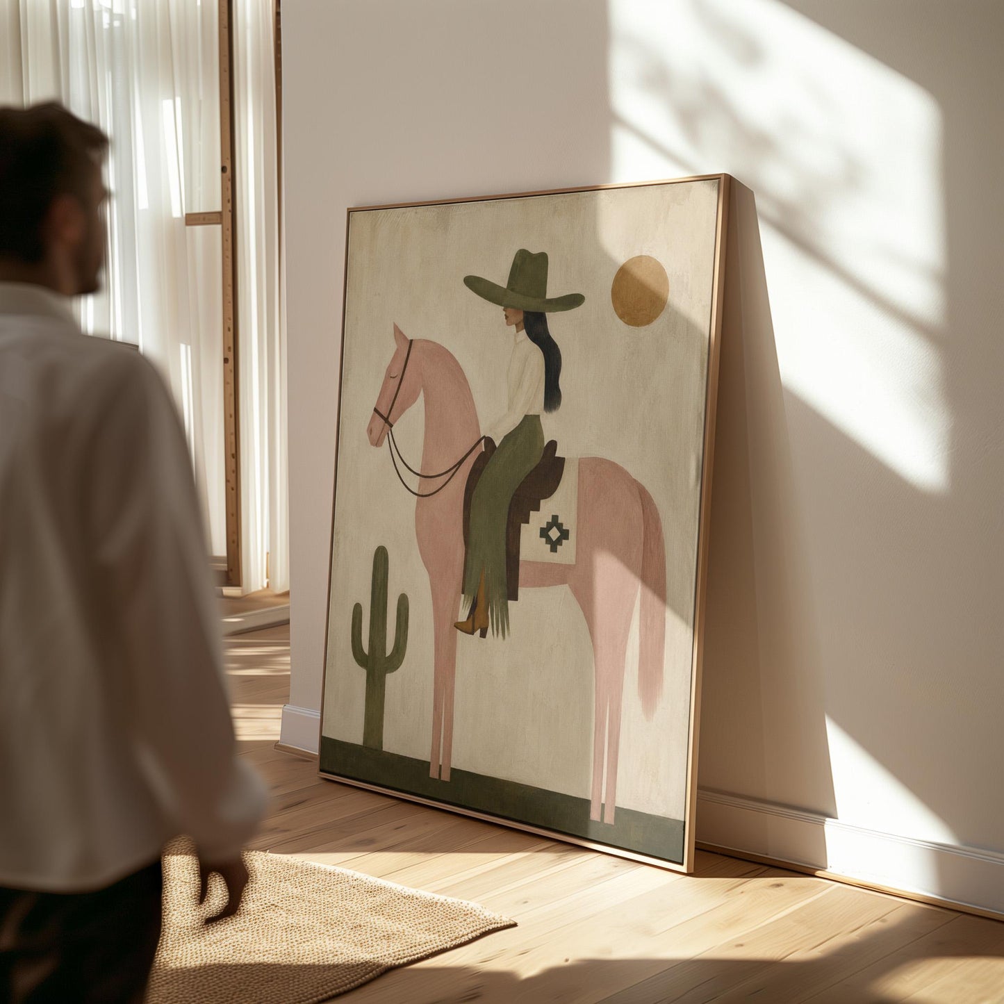 Cowgirl on a dusty pink horse beside a tall saguaro cactus, canvas print styled against a soft white wall