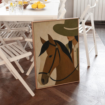 Bay horse in a bridle with a cowgirl in an olive hat behind, canvas wall art presented in a light, minimal room
