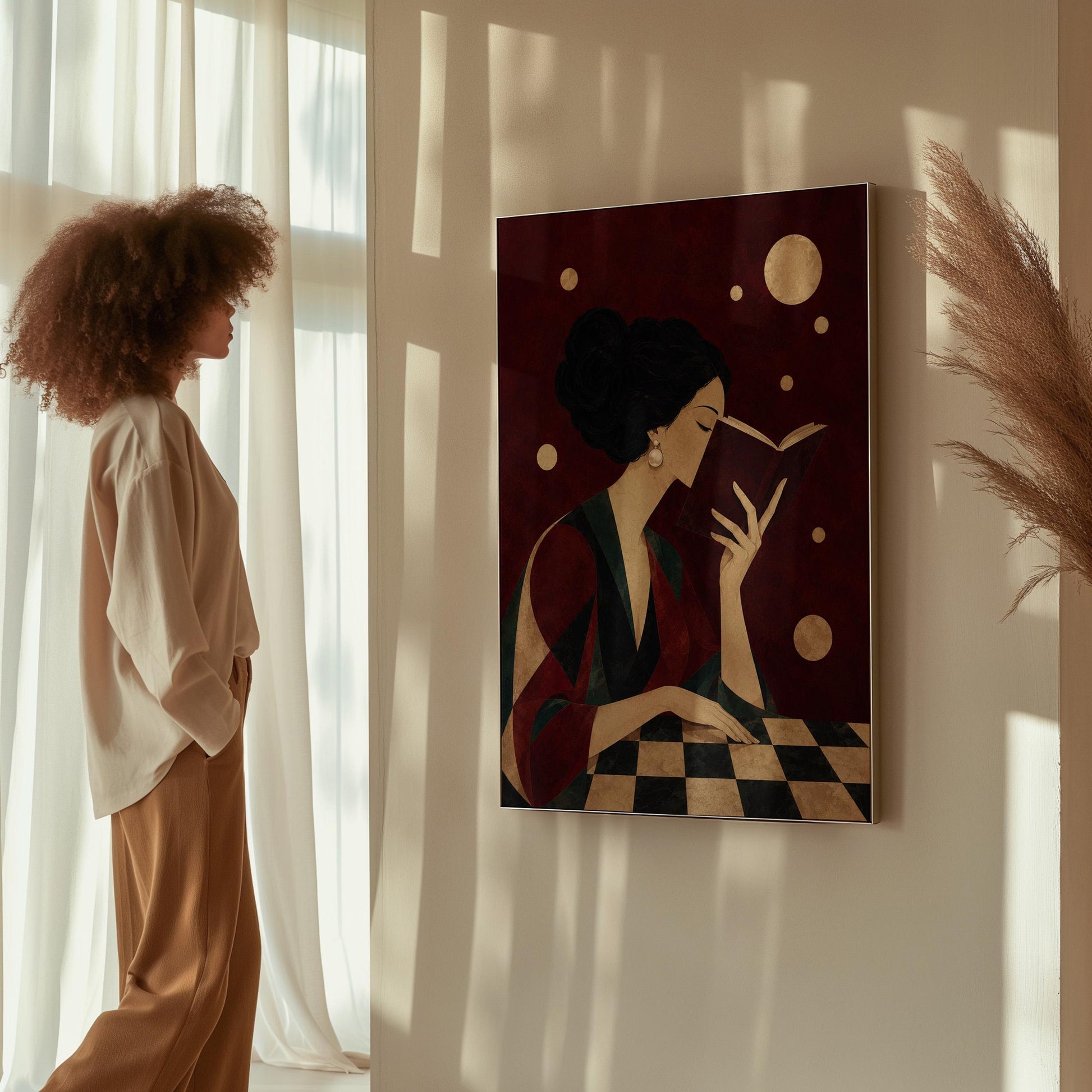 Dark haired woman in a faceted jewel toned gown reading an open book, canvas wall art on a quiet wall in a considered interior