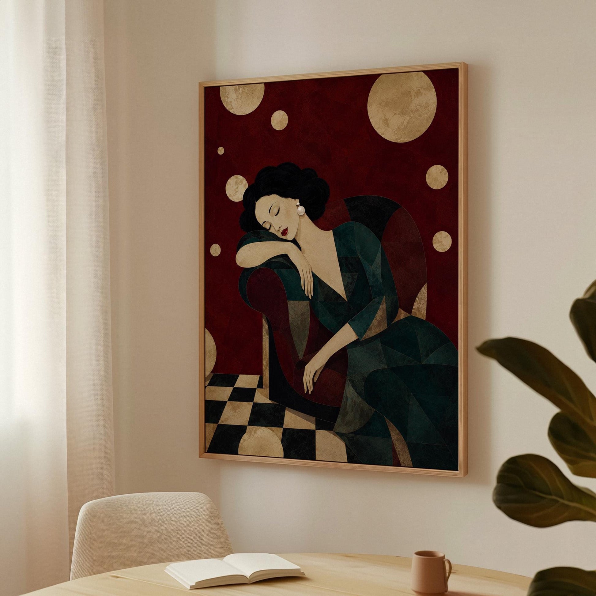 Dark haired woman asleep draped over the back of a deep red armchair, canvas print hanging in a calm, modern living space