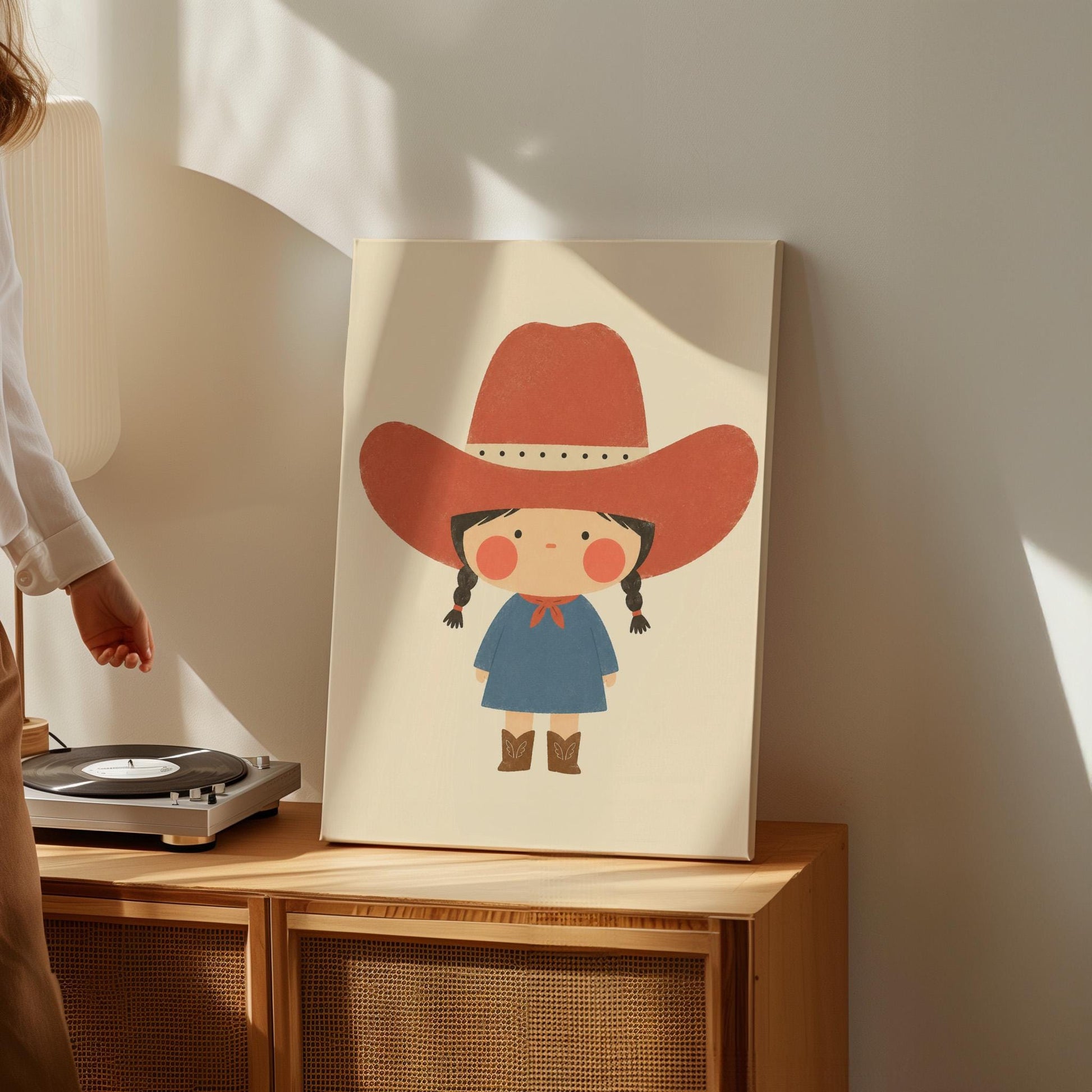 Little cowgirl with braids and rosy cheeks under an oversized red hat, canvas print displayed on a neutral wall in a styled interior