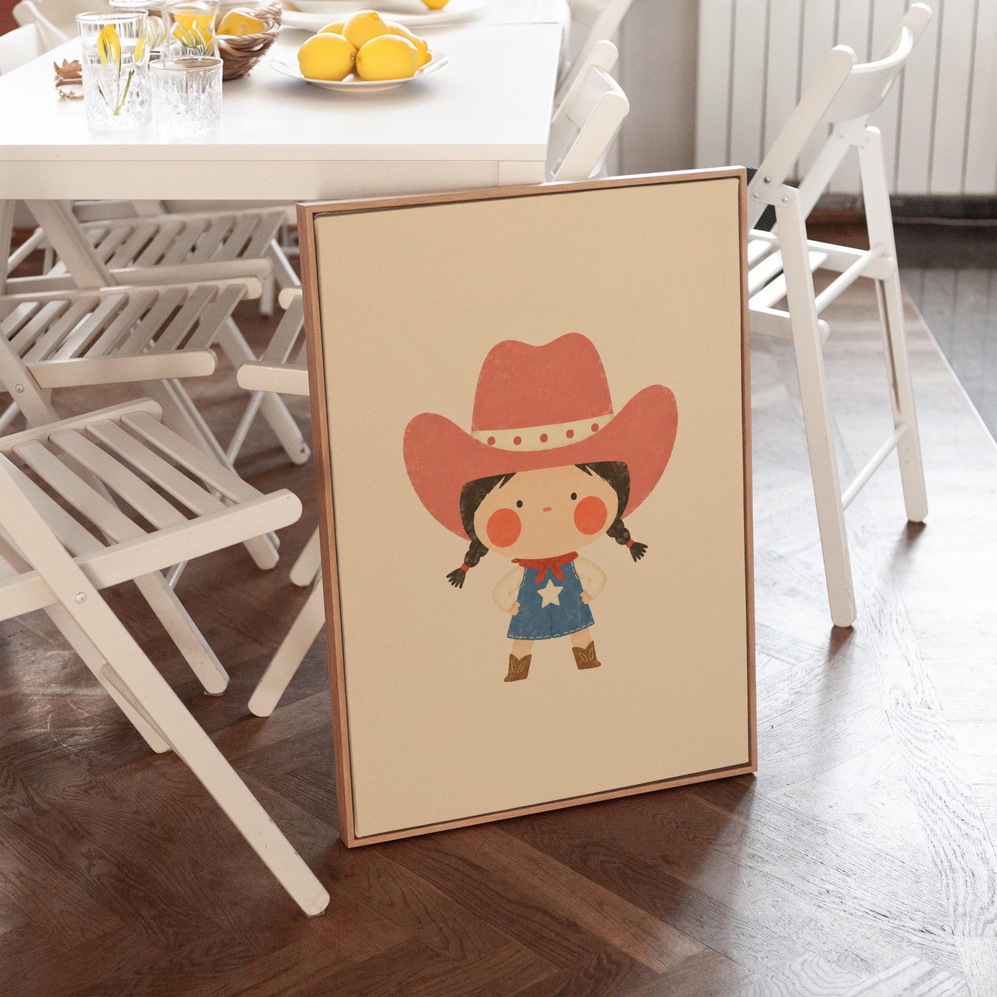 Small cowgirl in a star dress and coral hat with hands on hips, canvas wall art on a quiet wall in a considered interior