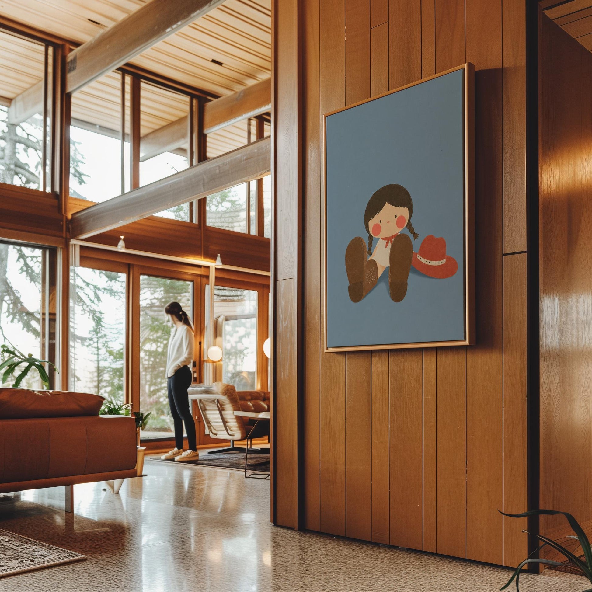 Little cowgirl sitting with big brown boots and a red hat, canvas print displayed on a neutral wall in a styled interior