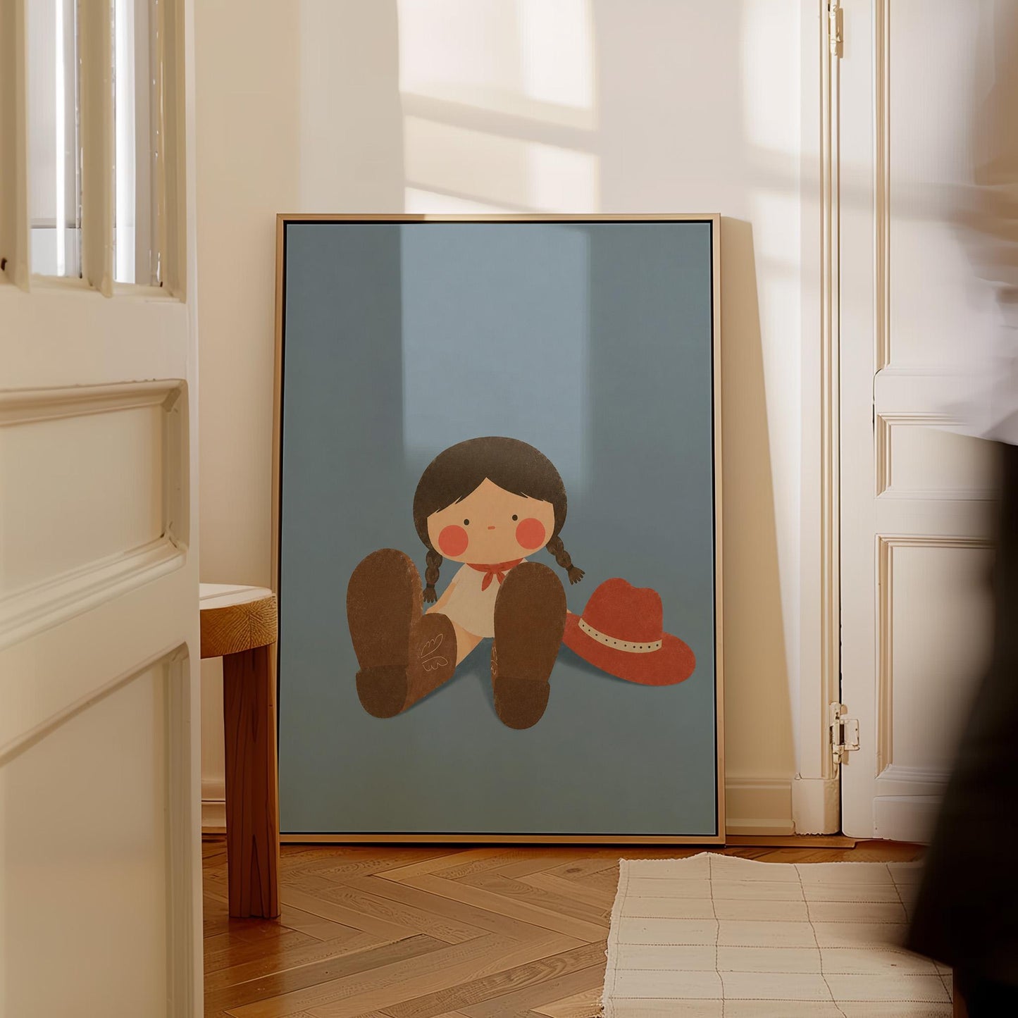 Little cowgirl sitting with big brown boots and a red hat, canvas wall art on a quiet wall in a considered interior