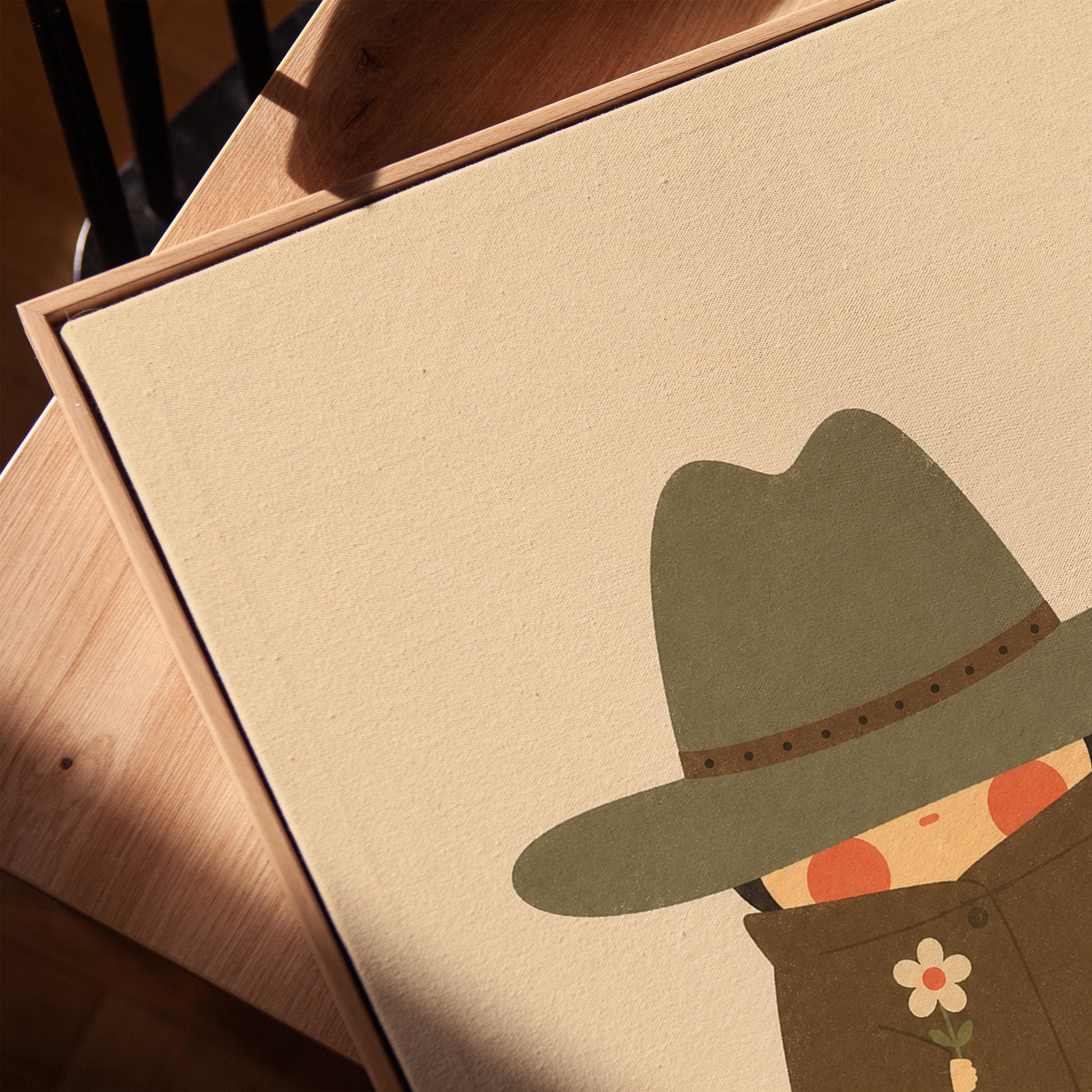 Tiny cowboy in a wide hat and fringed coat holding a daisy, canvas print in a warm, minimally styled interior