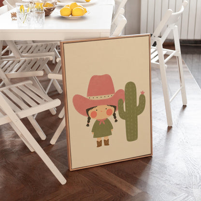 Little cowgirl in a pink hat next to a tall flowering cactus, canvas print styled against a soft white wall
