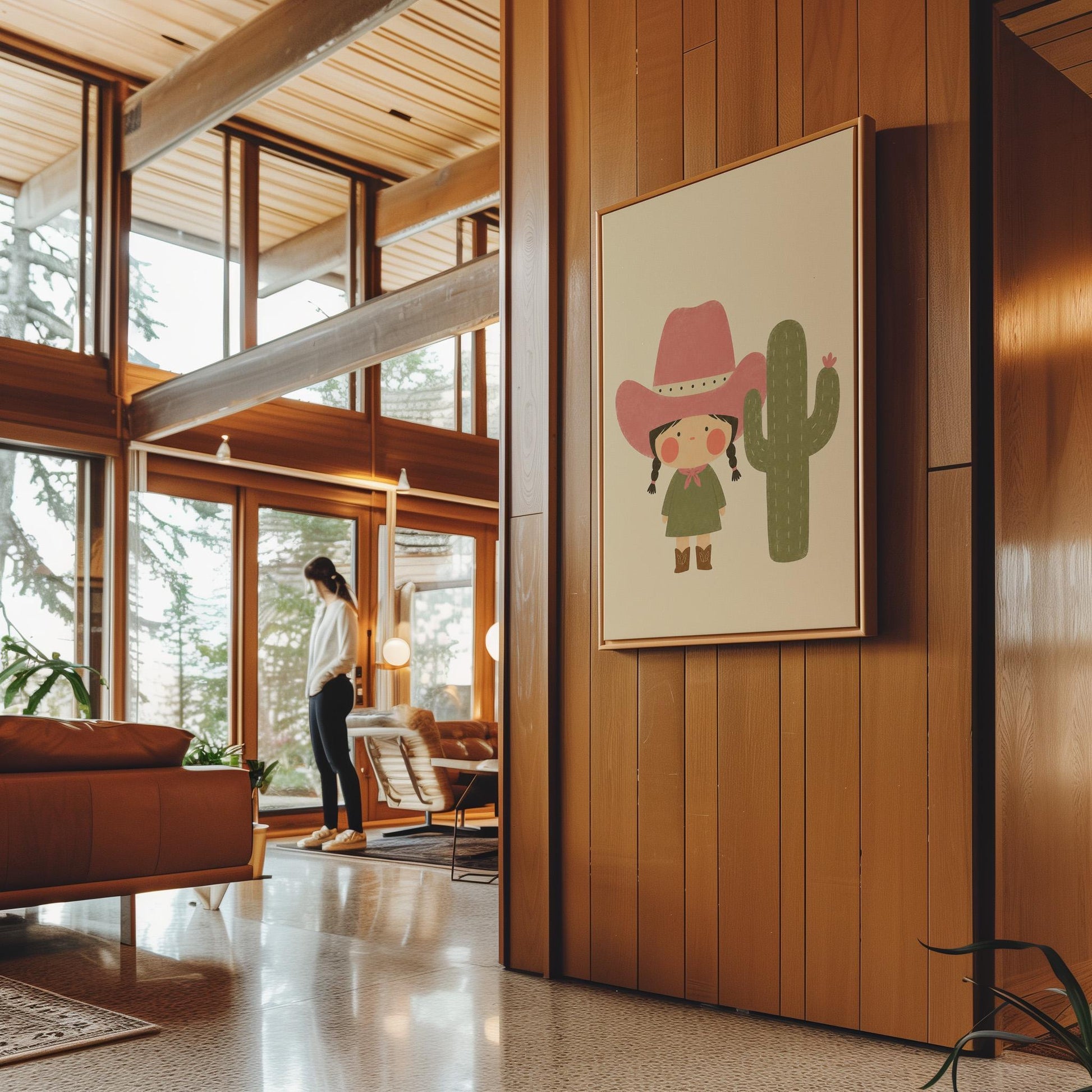Little cowgirl in a pink hat next to a tall flowering cactus, canvas print shown to scale in a furnished room