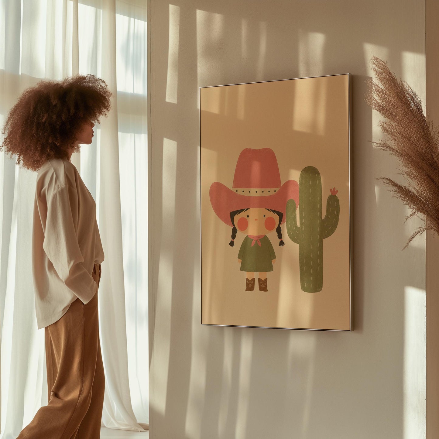 Little cowgirl in a pink hat next to a tall flowering cactus, canvas wall art styled against a soft white wall