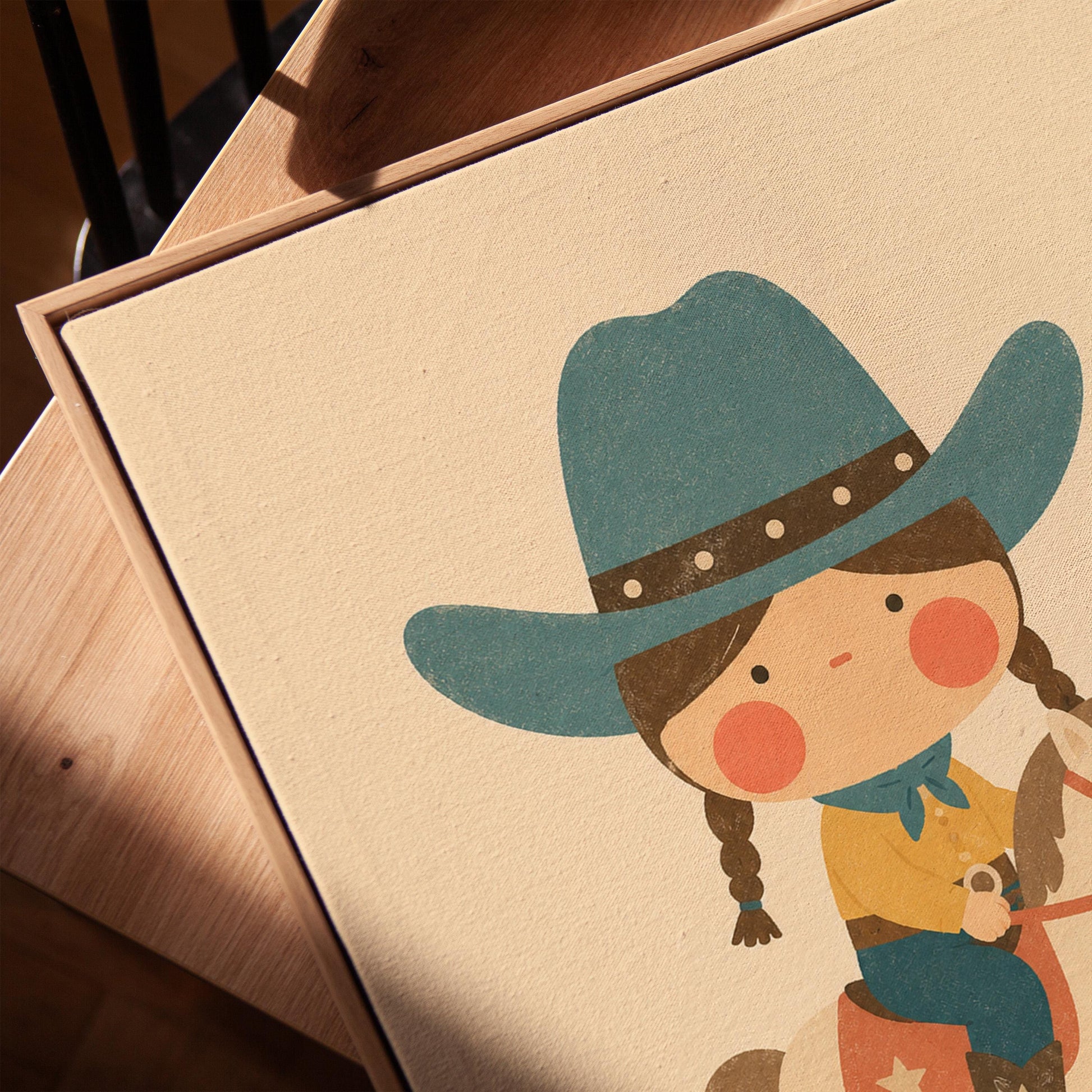 Child in a teal hat riding a cream rocking horse with stars, canvas print in a warm, minimally styled interior
