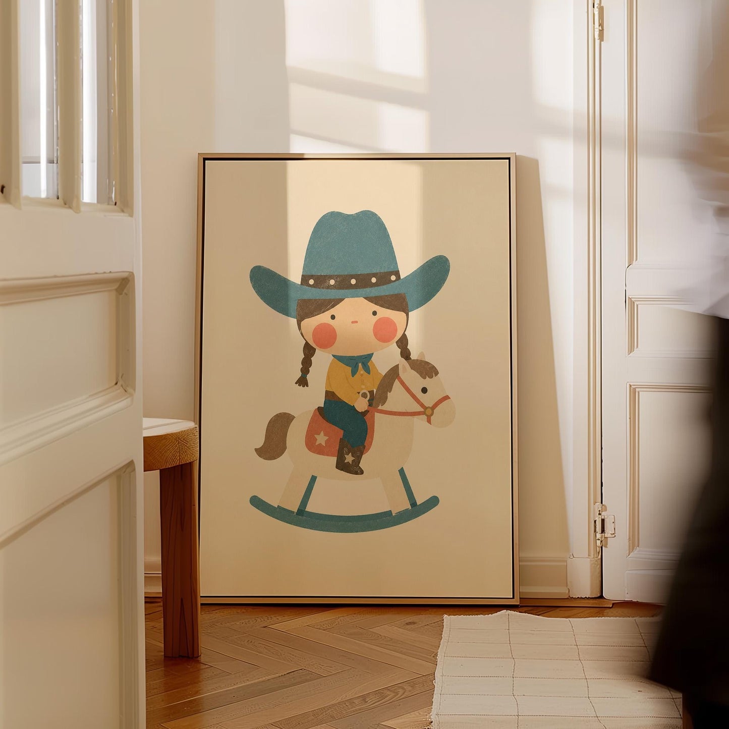 Child in a teal hat riding a cream rocking horse with stars, canvas print hanging in a calm, modern living space