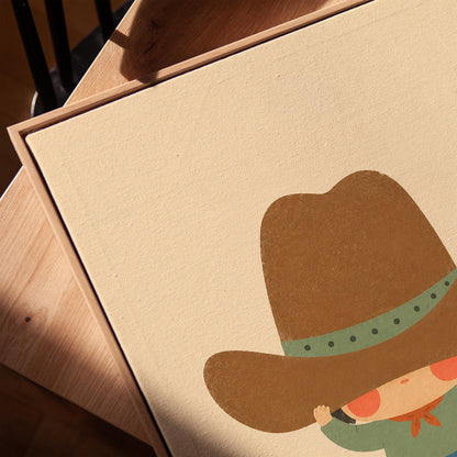 Child lifting an enormous brown cowboy hat above their eyes, canvas print in a warm, minimally styled interior