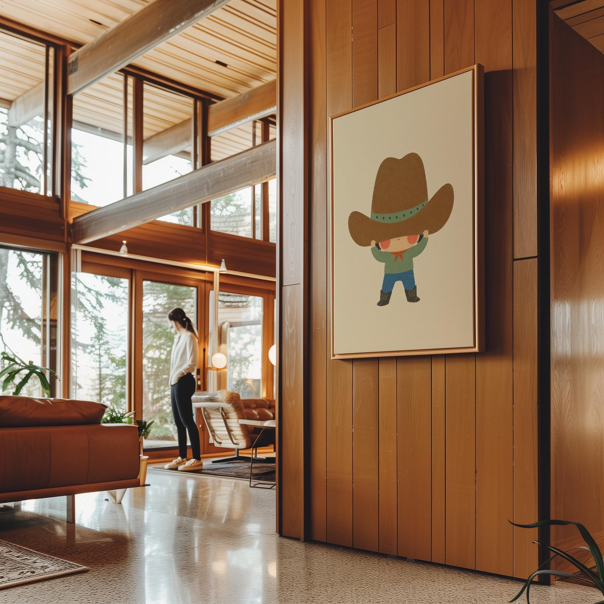Child lifting an enormous brown cowboy hat above their eyes, canvas wall art presented in a light, minimal room