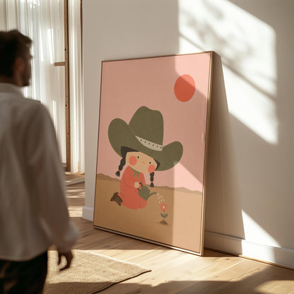 Cowgirl in a green hat watering a small flower in the desert, canvas print shown in a sunlit, contemporary room