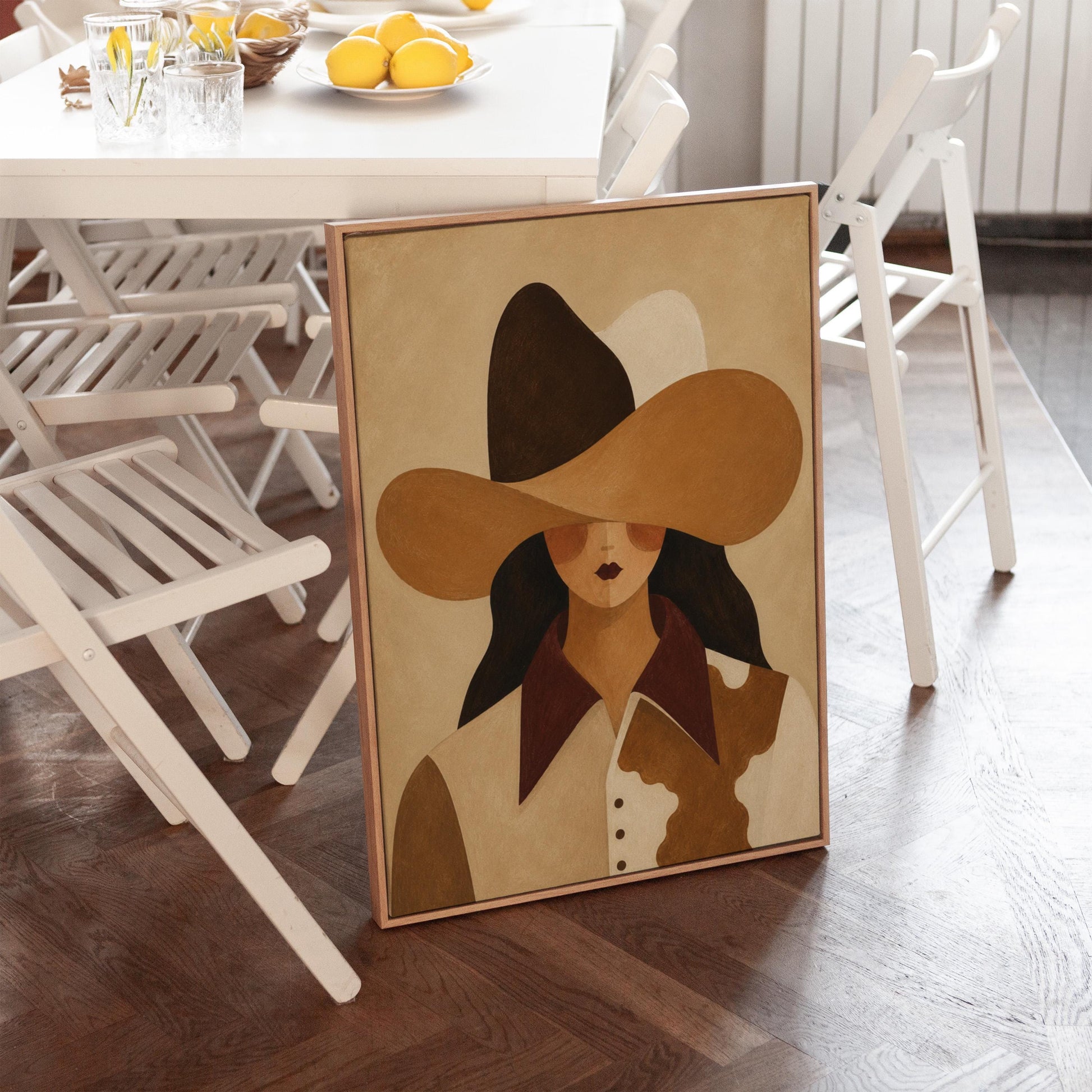 Cowgirl in a black and brown hat wearing a cow print shirt, canvas wall art presented in a light, minimal room