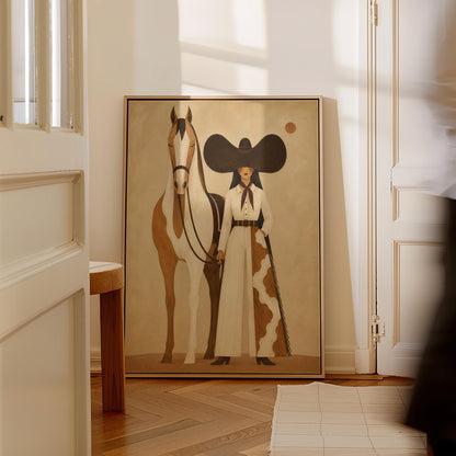 Cowgirl in a sculptural black hat standing with a horse in the desert sun, canvas print shown in a sunlit, contemporary room
