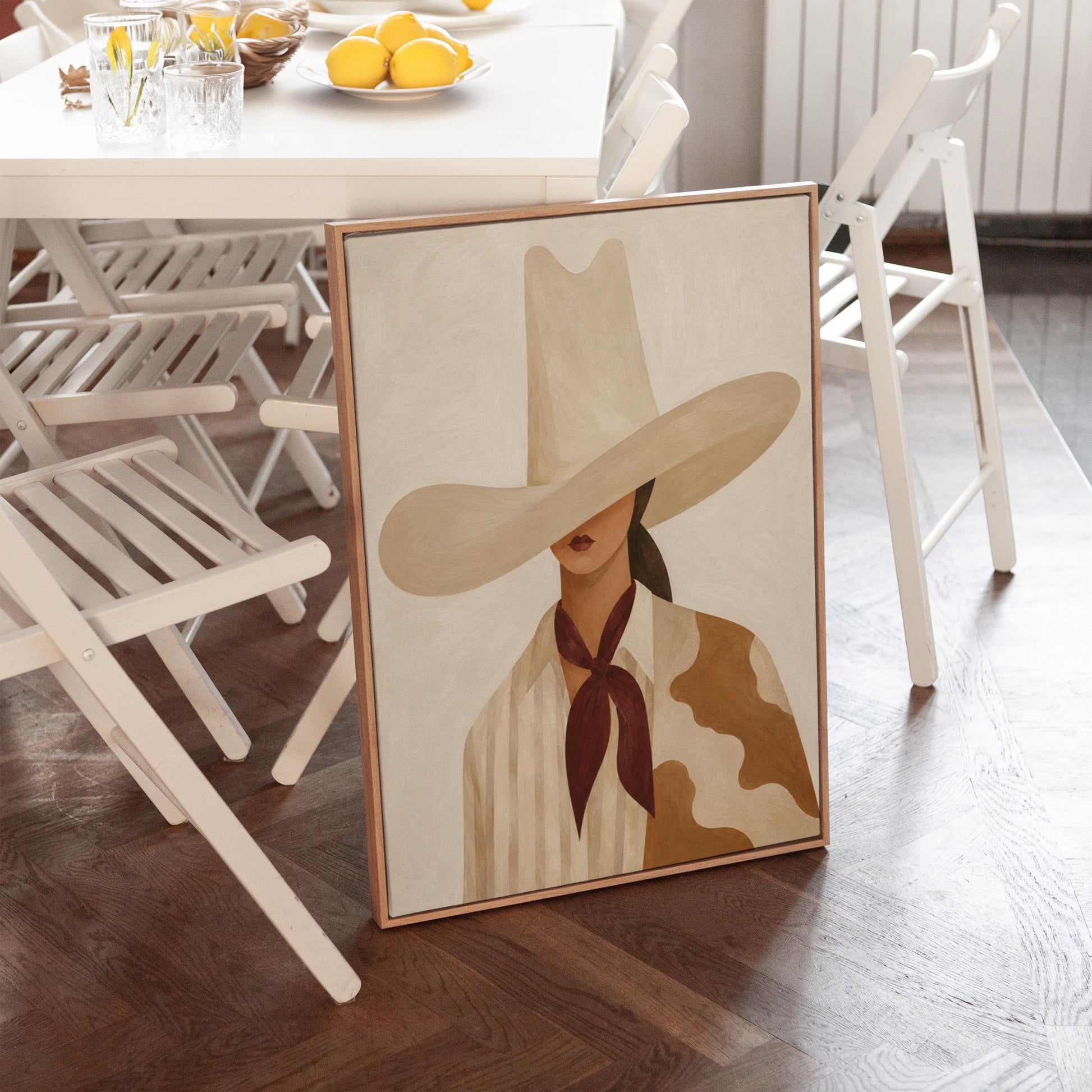 Cowgirl in a tall cream hat wearing a cowhide shawl and mauve scarf, canvas print presented in a light, minimal room