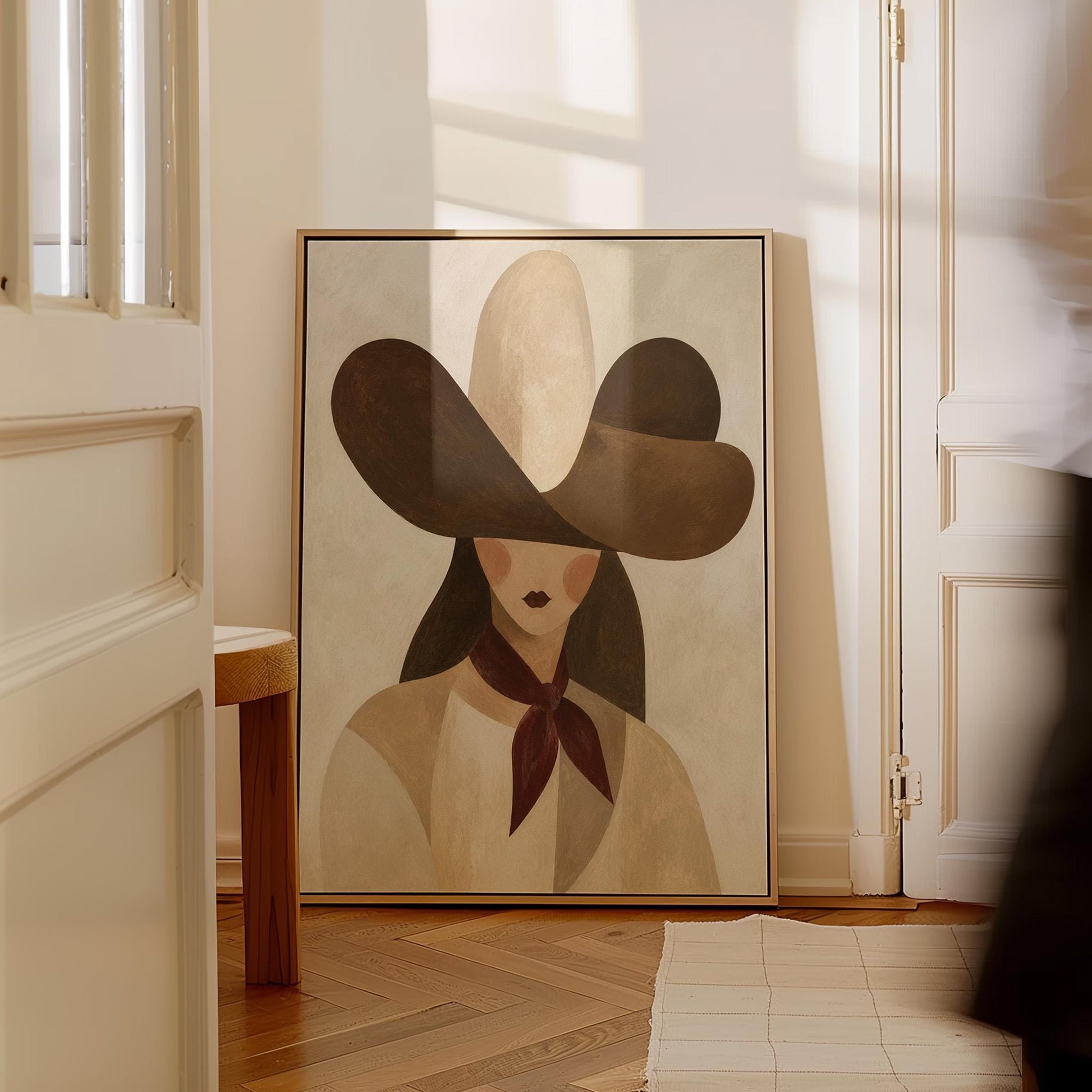 Woman in a deep brown cowboy hat with long hair and a wine red scarf, canvas print displayed on a neutral wall in a styled interior