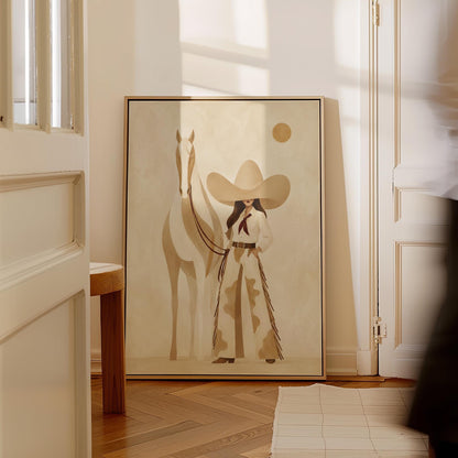 Cowgirl in cream chaps beside a pale horse under a small ochre sun, canvas print displayed on a neutral wall in a styled interior