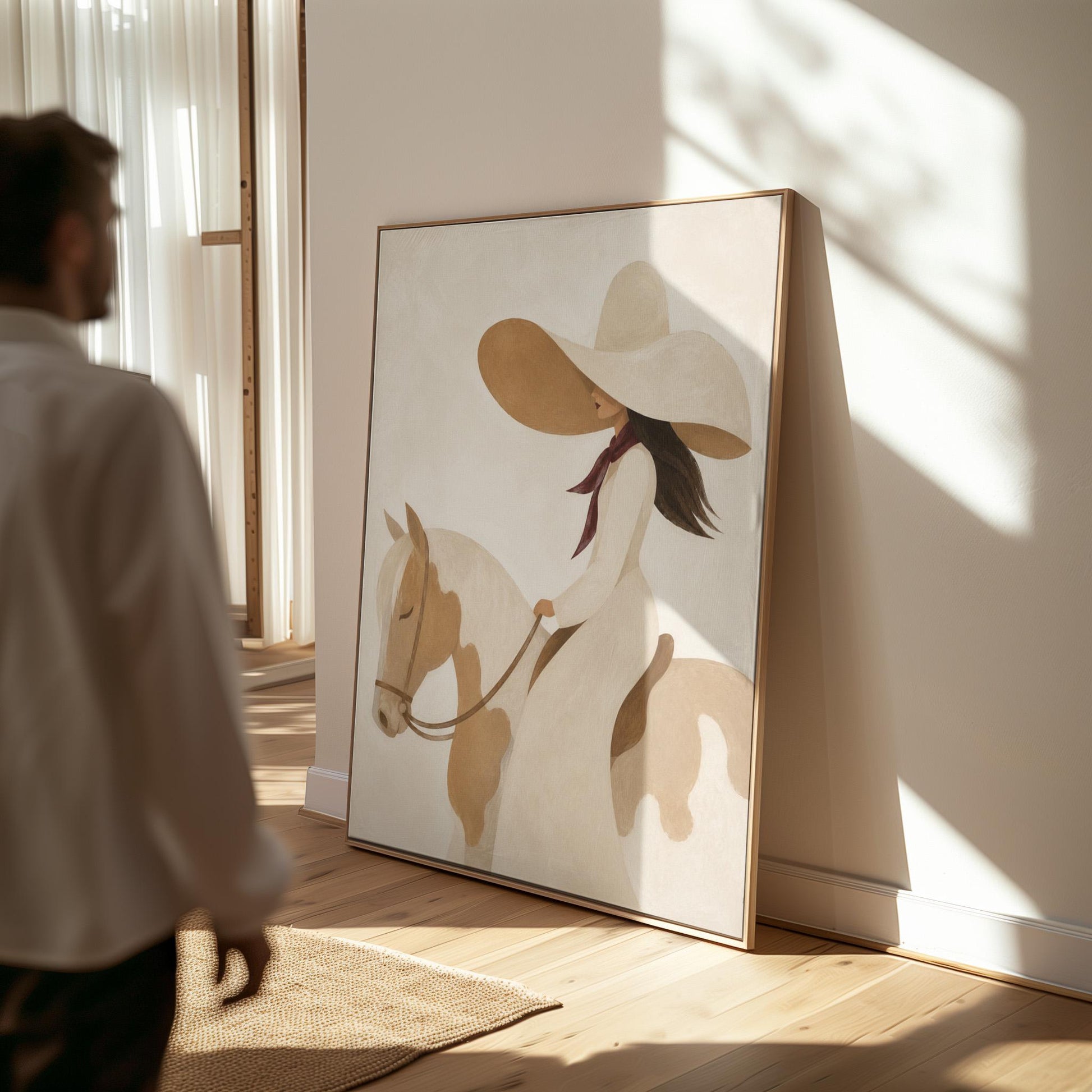 Woman in a long white dress and floppy hat riding a spotted horse, canvas wall art presented in a light, minimal room