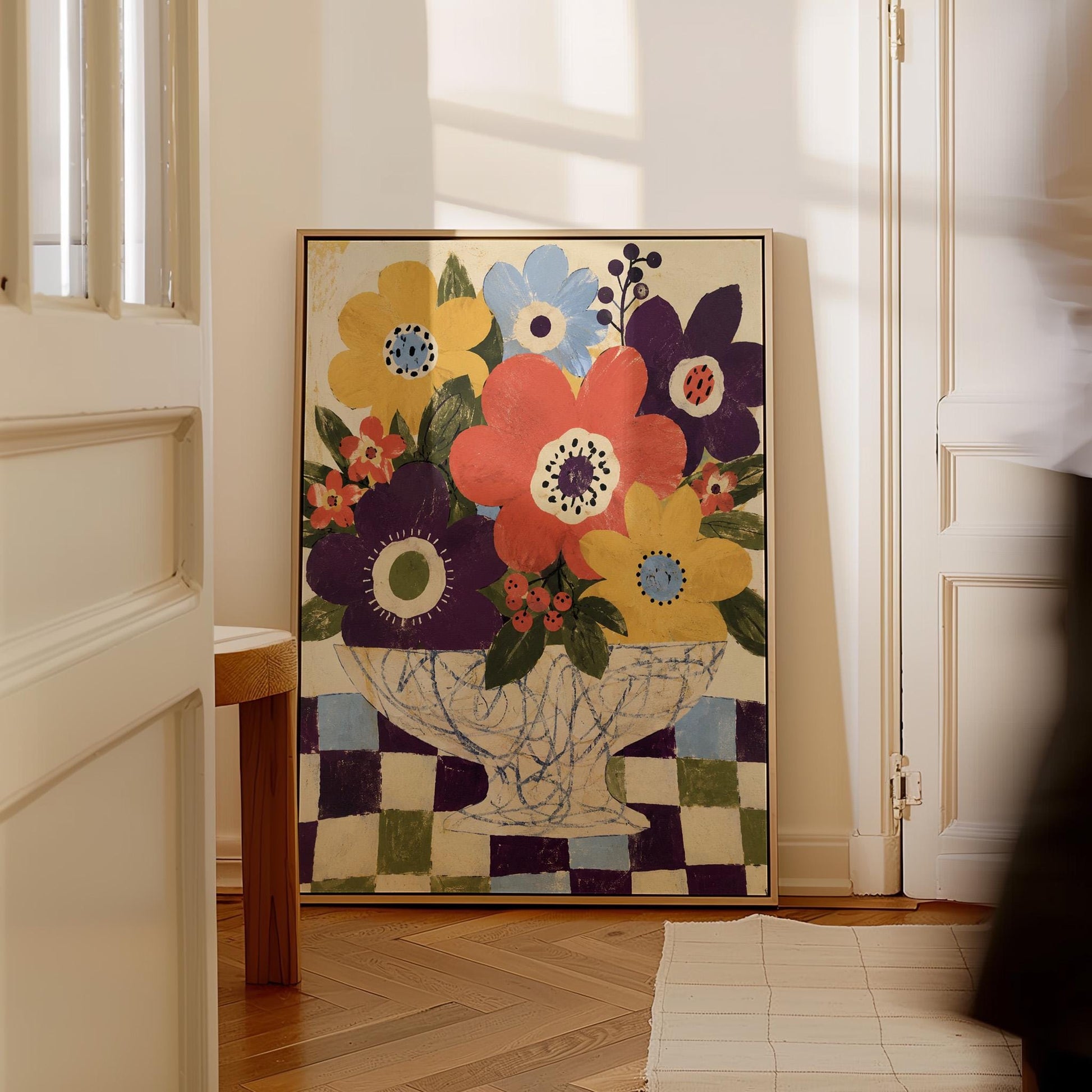 Bright folk bouquet in a white urn set on a checkerboard tabletop, canvas print shown in a sunlit, contemporary room