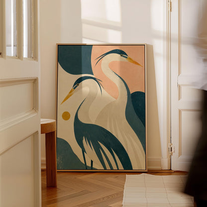 Two great herons with yellow beaks against a peach and teal sky, canvas print displayed on a neutral wall in a styled interior