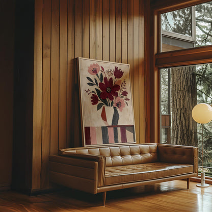 Burgundy and dusty pink flowers in a striped vase on a striped table, canvas print hanging in a calm, modern living space