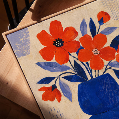 Scarlet poppies in a cobalt vase with oranges on a blue striped cloth, canvas print in a warm, minimally styled interior