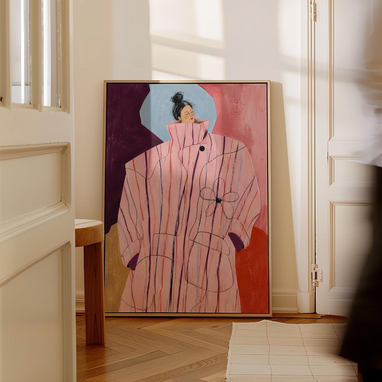 Woman in an oversized pink striped coat against plum and coral blocks, canvas print displayed on a neutral wall in a styled interior