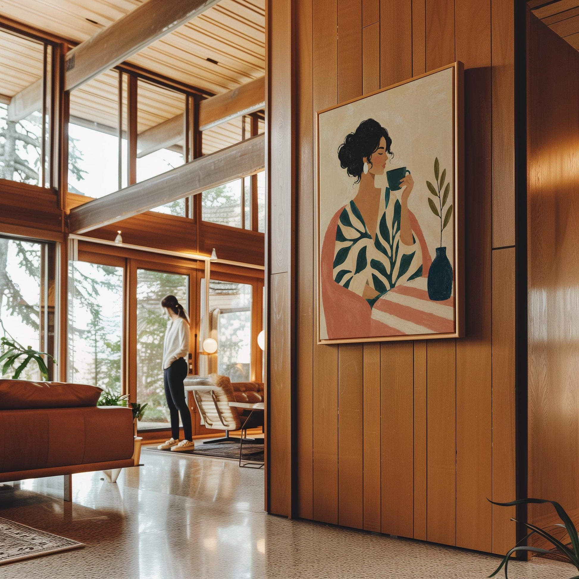 Woman in a leaf print robe drinking from a teal cup beside a vase, canvas print hanging in a calm, modern living space