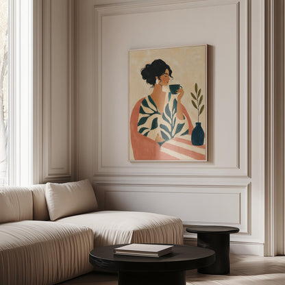 Woman in a leaf print robe drinking from a teal cup beside a vase, canvas print presented in a light, minimal room